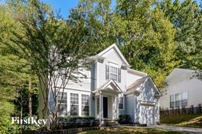 Charlotte house for rent - a blue and white house with trees in front of it