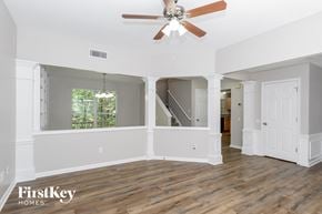 Charlotte house for rent - a living room with white walls and a ceiling fan