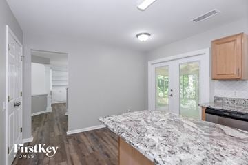 Charlotte house for rent - a kitchen with a marble counter top in a new home