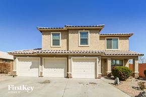 Buckeye house for rent - a beige house with white garage doors