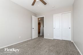 Buckeye house for rent - a bedroom with two closets and a ceiling fan
