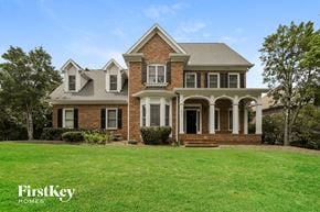 Gastonia house for rent - a large brick house with a lawn in front of it