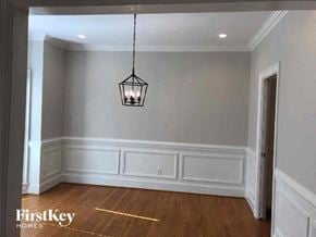 Gastonia house for rent - a empty dining room with a light hanging from the ceiling