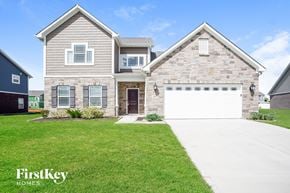 New Palestine house for rent - A house with a garage and a driveway in front of it.