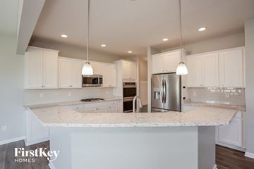 New Palestine house for rent - A modern kitchen with a marble countertop and stainless steel appliances.