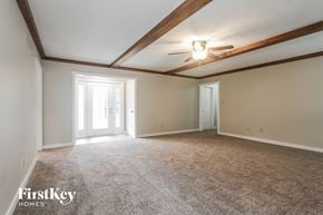 Carmel house for rent - A spacious room with a carpeted floor and a ceiling fan.