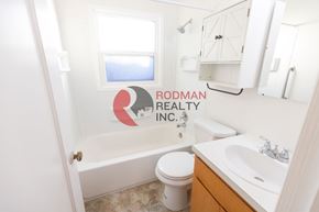 Longview apartment for rent - A bathroom with a toilet, sink, and bathtub.