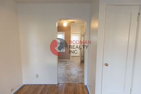 Longview apartment for rent - A hallway with a door on the right and a window in the distance.