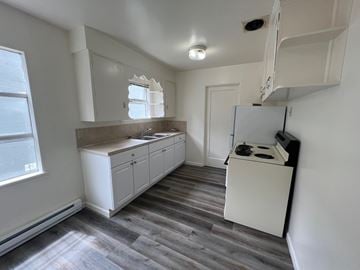 Longview apartment for rent - A kitchen with white cabinets and a white fridge.