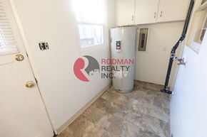 Longview apartment for rent - A room with Rodman Realty Inc. logo on the wall.
