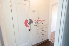 Longview apartment for rent - A white door with Rodman Realty Inc. logo on it.