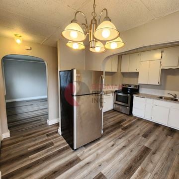 Castle Rock apartment for rent - A kitchen with a refrigerator, oven, and cabinets.