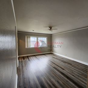 Castle Rock apartment for rent - A room with a wooden floor and a ceiling fan.