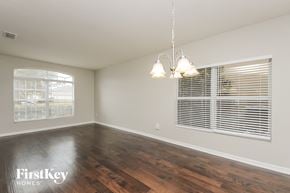 Orlando house for rent - a living room with wood floors and a large window