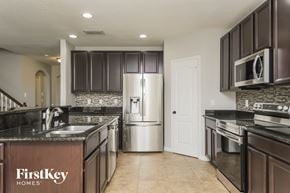 Orlando house for rent - a kitchen with granite counter tops and stainless steel appliances