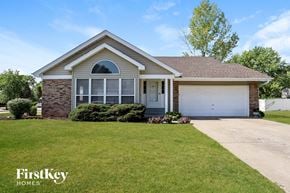 St Charles house for rent - a home with a lawn and a white garage door