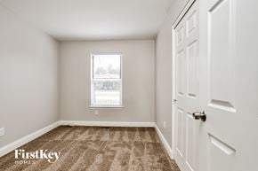 St Charles house for rent - a bedroom with carpeted floors and a window