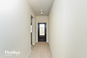 San Antonio house for rent - a hallway with white walls and a door to a house