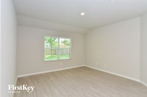 San Antonio house for rent - a living room with white walls and wooden floors and a window