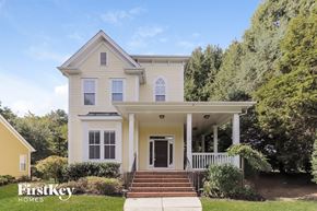 Huntersville house for rent - a white house with yellow trim and a porch