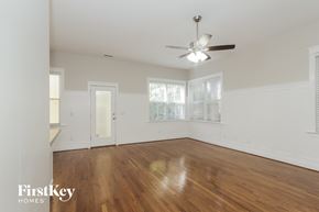 Huntersville house for rent - a living room with wood floors and a ceiling fan