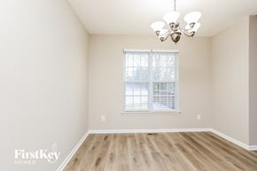 Lebanon house for rent - a bedroom with hardwood floors and a window and a chandelier
