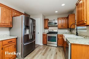 Lebanon house for rent - a kitchen with wooden cabinets and stainless steel appliances