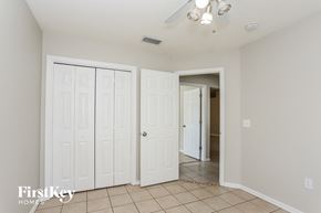 Valrico house for rent - a bedroom with two closets and a door to a hallway