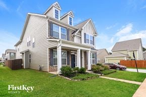 Huntersville house for rent - a beige house with a yard in front of it
