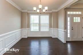 Huntersville house for rent - an empty dining room with white walls and a chandelier