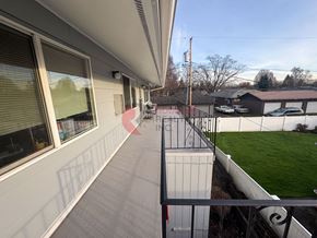 Longview apartment for rent - A balcony with a railing overlooking a green field.