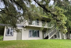 Kelso apartment for rent - A house with a green lawn and trees in the front.