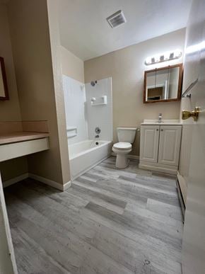 Kelso apartment for rent - A bathroom with a toilet, sink, and bathtub.