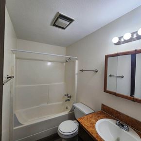 Kelso apartment for rent - A small bathroom with a toilet, sink, and bathtub.