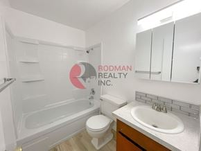 Kelso apartment for rent - A white bathroom with Rodman Realty Inc. written on the wall.