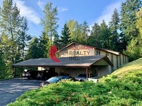 Kelso apartment for rent - A building with a red sign that says "Brodman Ranch" is surrounded by trees.
