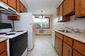 Longview apartment for rent - A kitchen with a black stove top oven and a white refrigerator.