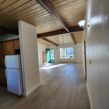 Longview apartment for rent - A kitchen with a white refrigerator and wooden cabinets.