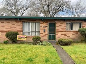 Longview apartment for rent - A red brick house with a sign that says "For Rent" and a phone number.