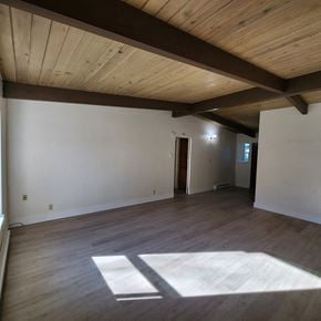 Longview apartment for rent - A room with wooden floors and a wooden ceiling.