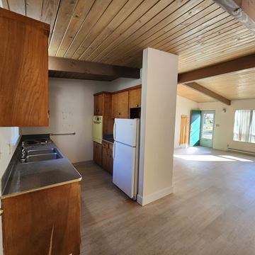 Longview apartment for rent - A kitchen with wooden cabinets and a white fridge.