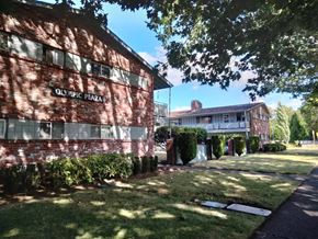 Longview apartment for rent - A red brick building with the words Olympic Plaza on it.