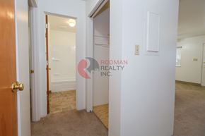 Longview apartment for rent - A hallway with a door on the left and a wall on the right with a sign that says "Rodman Realty Inc.".