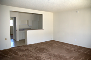Glendora apartment for rent - an empty living room with a kitchen in the background