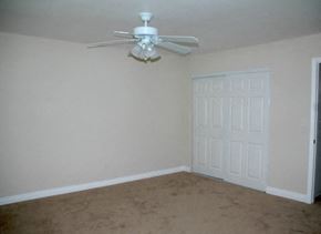 Glendora apartment for rent - an empty room with a ceiling fan and a door