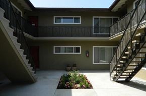 West Covina apartment for rent - an apartment building with a staircase and a courtyard