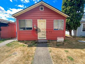 Kelso apartment for rent - A red house with a sign that says "PROPERTY REALTY INC FOR RENT".