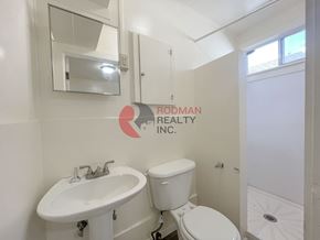 Kelso apartment for rent - A white bathroom with a sink, toilet and a window.
