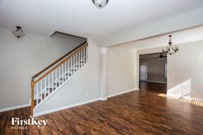 Charlotte house for rent - a living room with a staircase and a hard wood floor