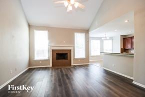 Crosby house for rent - an empty living room with wood floors and a fireplace